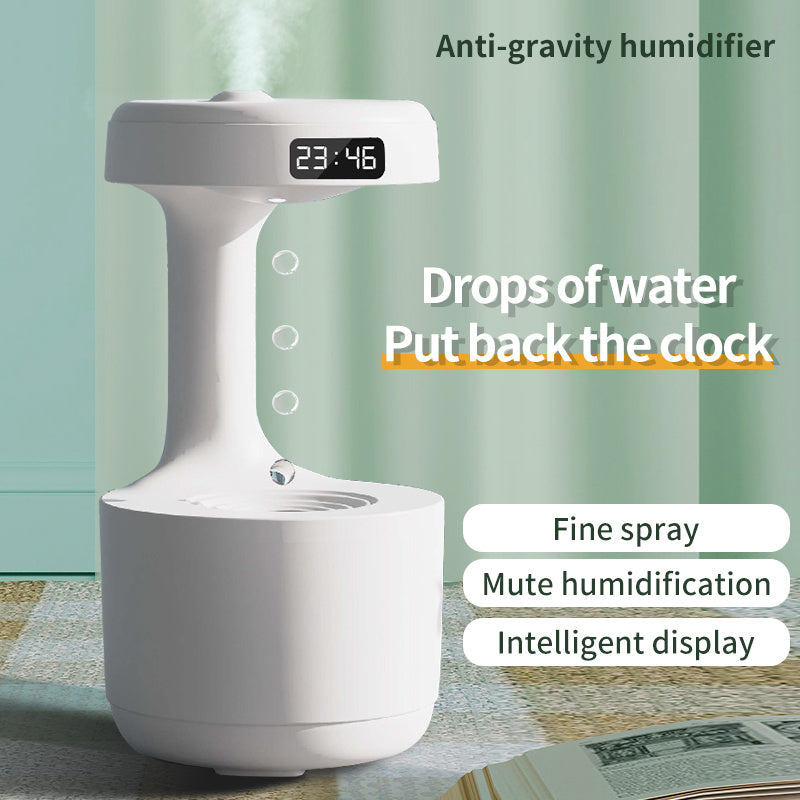 a white device with a digital clock and water droplets with text: 'Anti-gravity humidifier 23:46 Drops of water Put back the clock Fine spray Mute humidification Intelligent display'