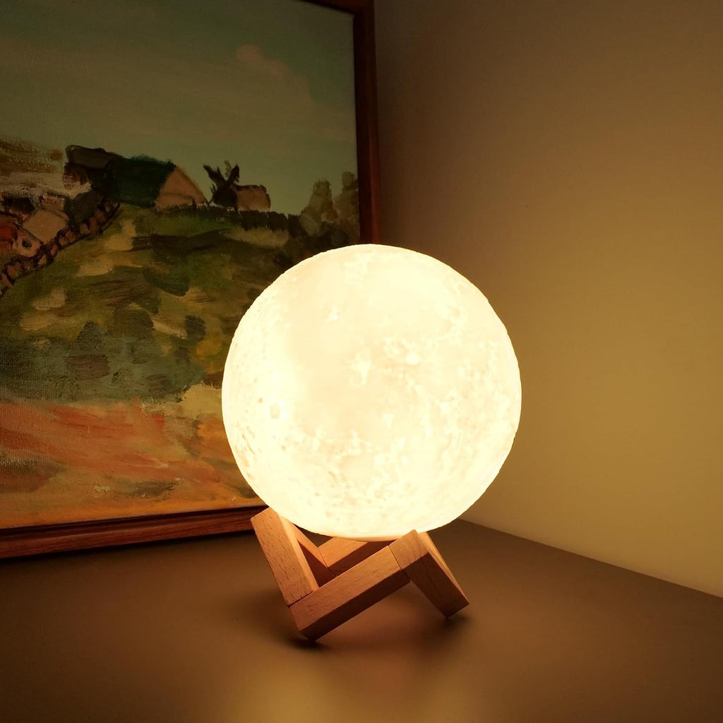 a lit moon lamp on a stand